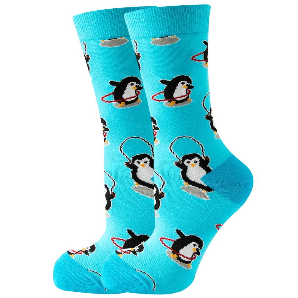 A pair of blue ankle socks with a playful penguin pattern, featuring penguins in various poses like skipping rope and hula hooping.