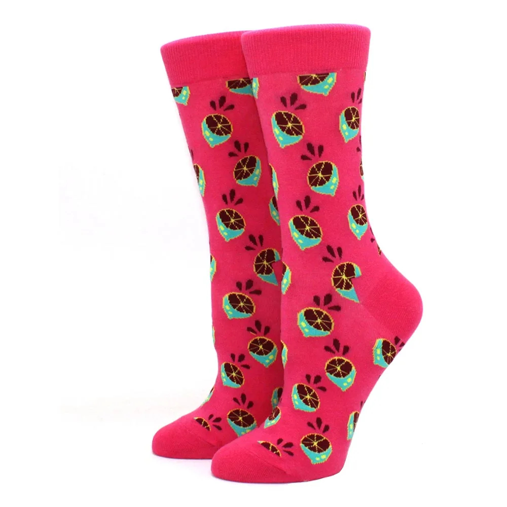 Pair of pink socks with fruit pattern on a white background
