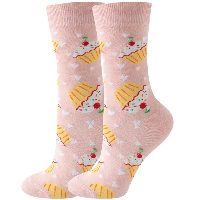 A pair of pink crew socks with an allover pattern of frosted sprinkled cupcakes, cherries, and tiny white hearts.