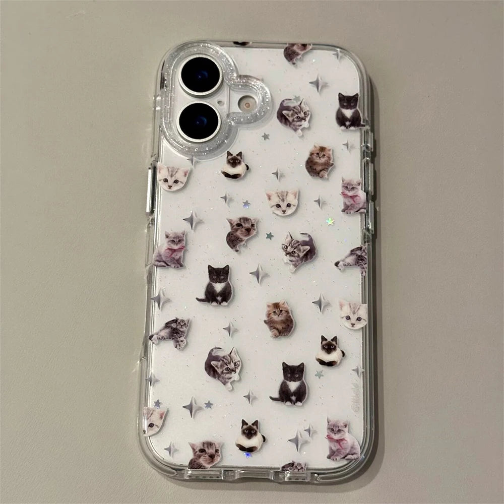 A clear protective phone case featuring a playful pattern of small cat illustrations and silver glitter stars, shown on a light gray background.