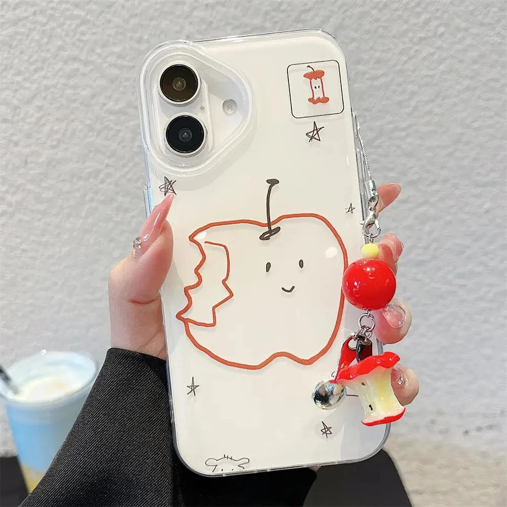 A hand holding a clear phone case decorated with a cartoonish bitten apple outline, small star doodles, and a red-and-white mushroom charm with a silver bell, against a light textured wall.