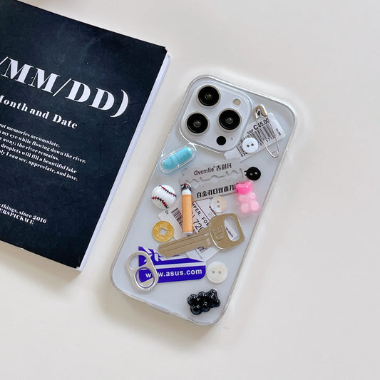 Phone case with various charms on a white surface
