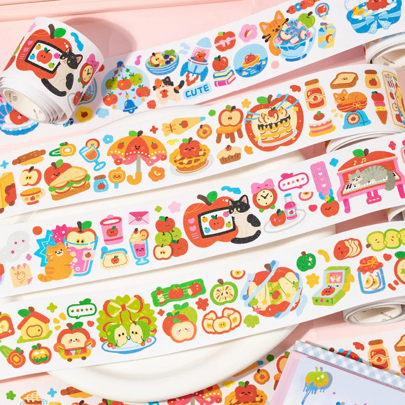 Colorful washi tape rolls with cute designs on a pink background