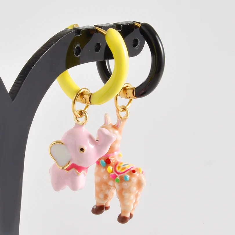 Keychain with pink elephant and llama charms on a stand against a light gray background