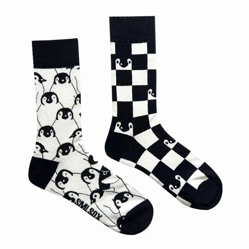Two pairs of socks with penguin design on a white background