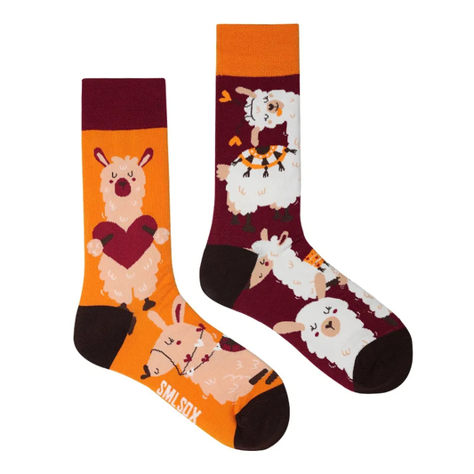 Two socks with animal designs on an orange and purple background