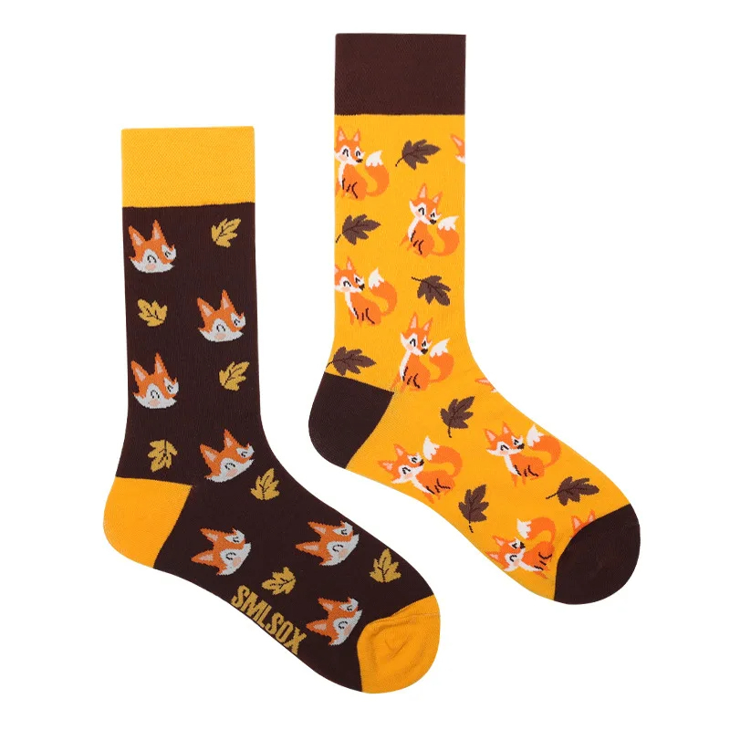 Pair of socks with fox and leaf pattern on a white background