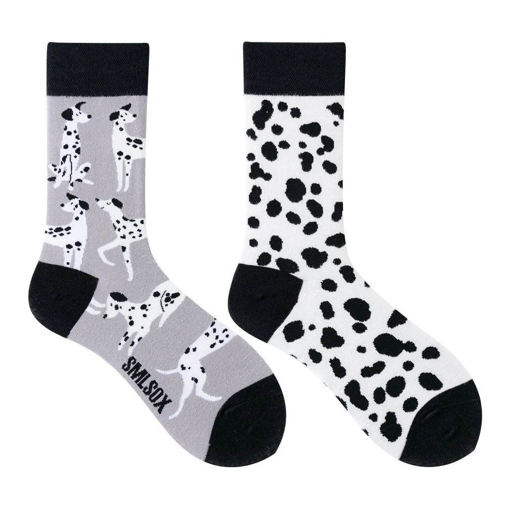 Two socks with dalmatian pattern on a white background