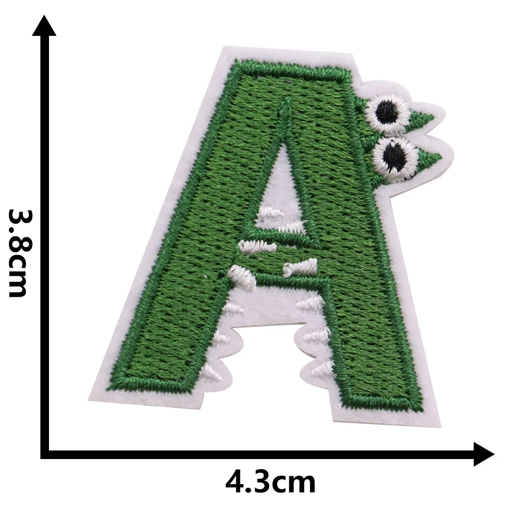 Green letter 'A' patch with cartoon alligator face on a white background