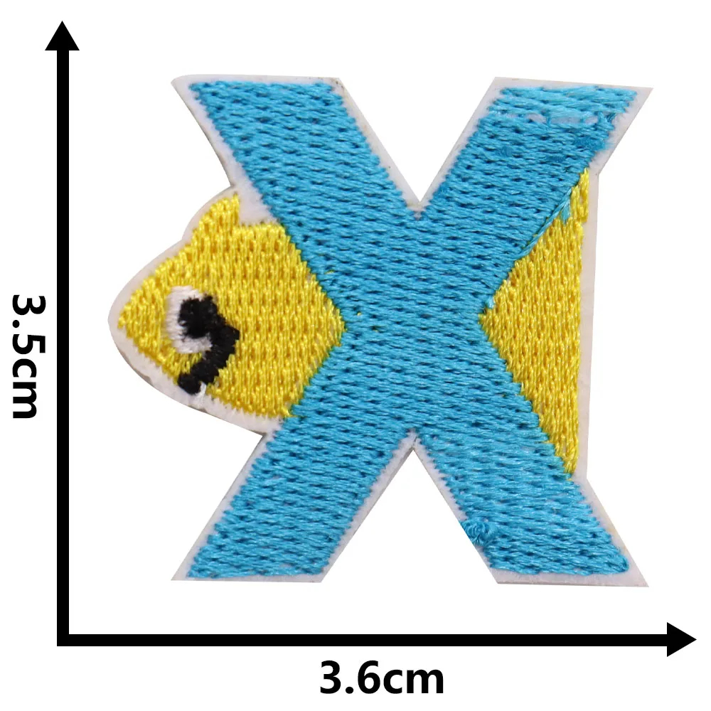 Letter 'X' patch with a fish design, shown with dimensions on a white background.
