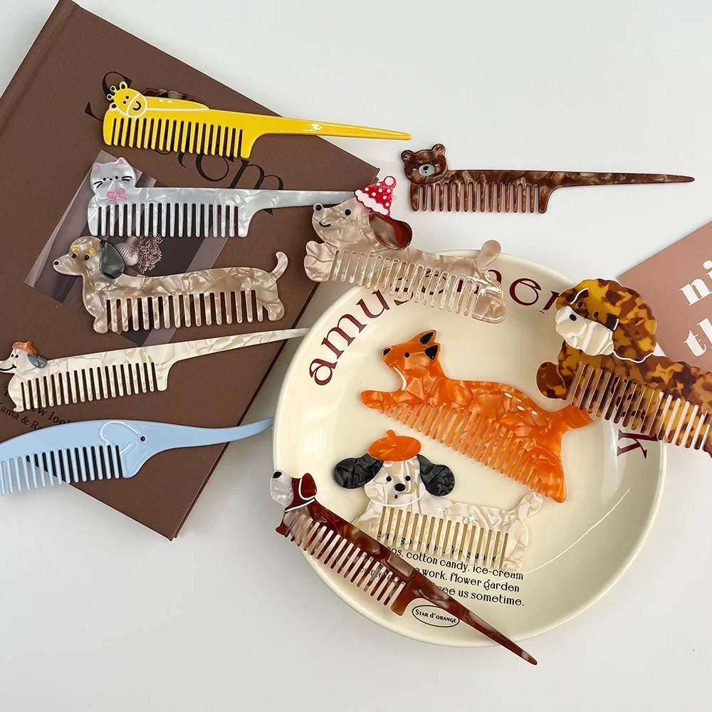 Collection of decorative animal-themed combs on a white surface with a book and decorative plate.