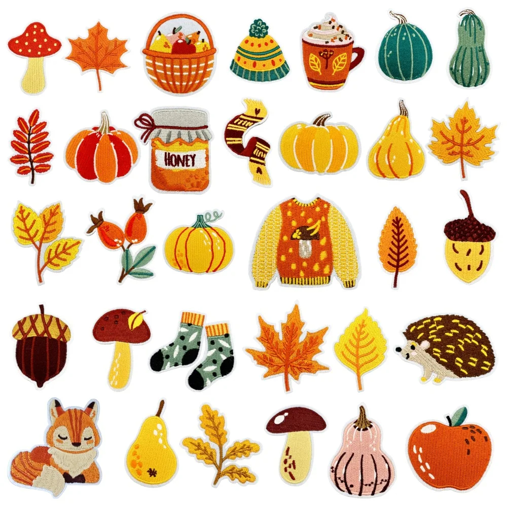 Collection of colorful autumn-themed embroidered iron-on patches including pumpkins, leaves, and a sweater.
