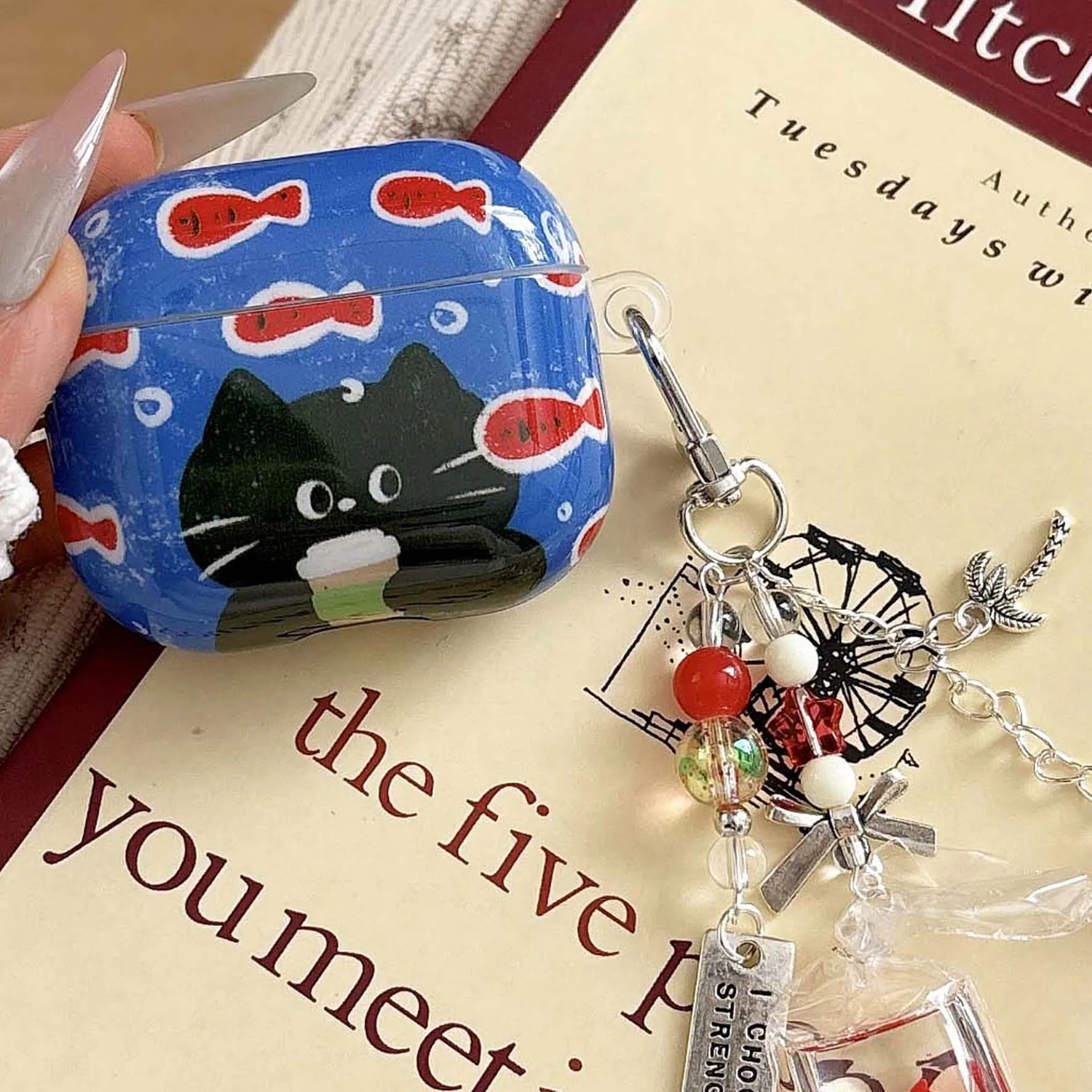 Blue case with a black cat design on a book