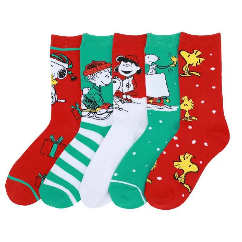 Set of four Christmas-themed socks with Peanuts characters on a white background
