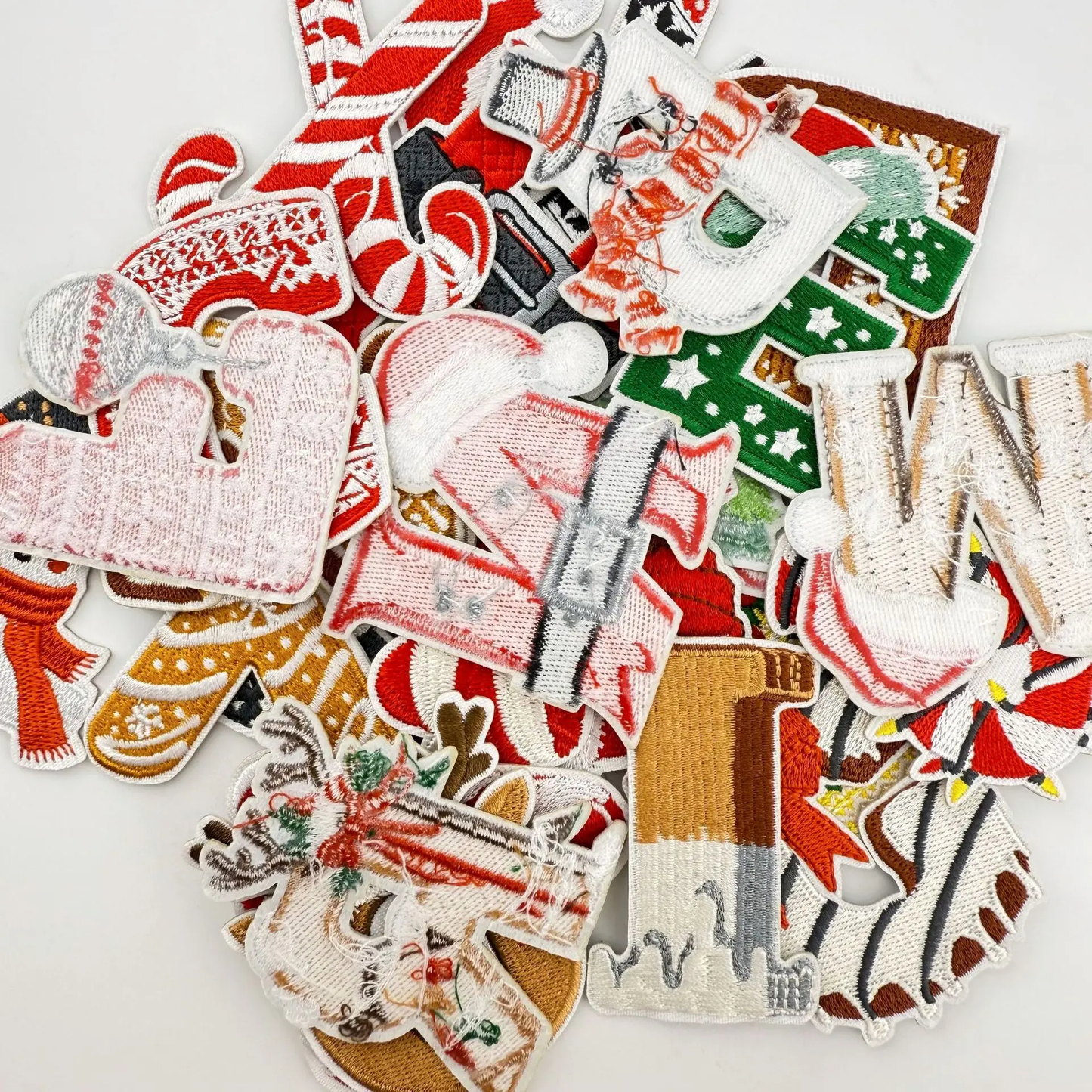 Collection of Christmas-themed embroidered patches on a white background