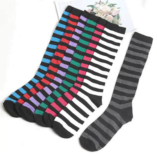 Four pairs of colorful striped socks on a white background