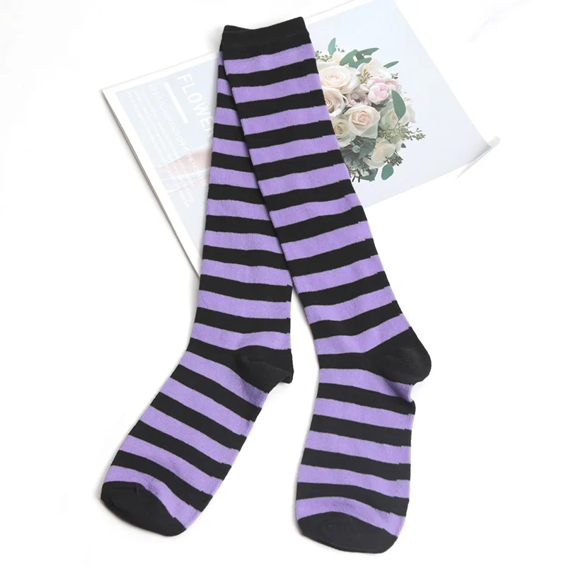 Purple and black striped socks on a magazine with floral design