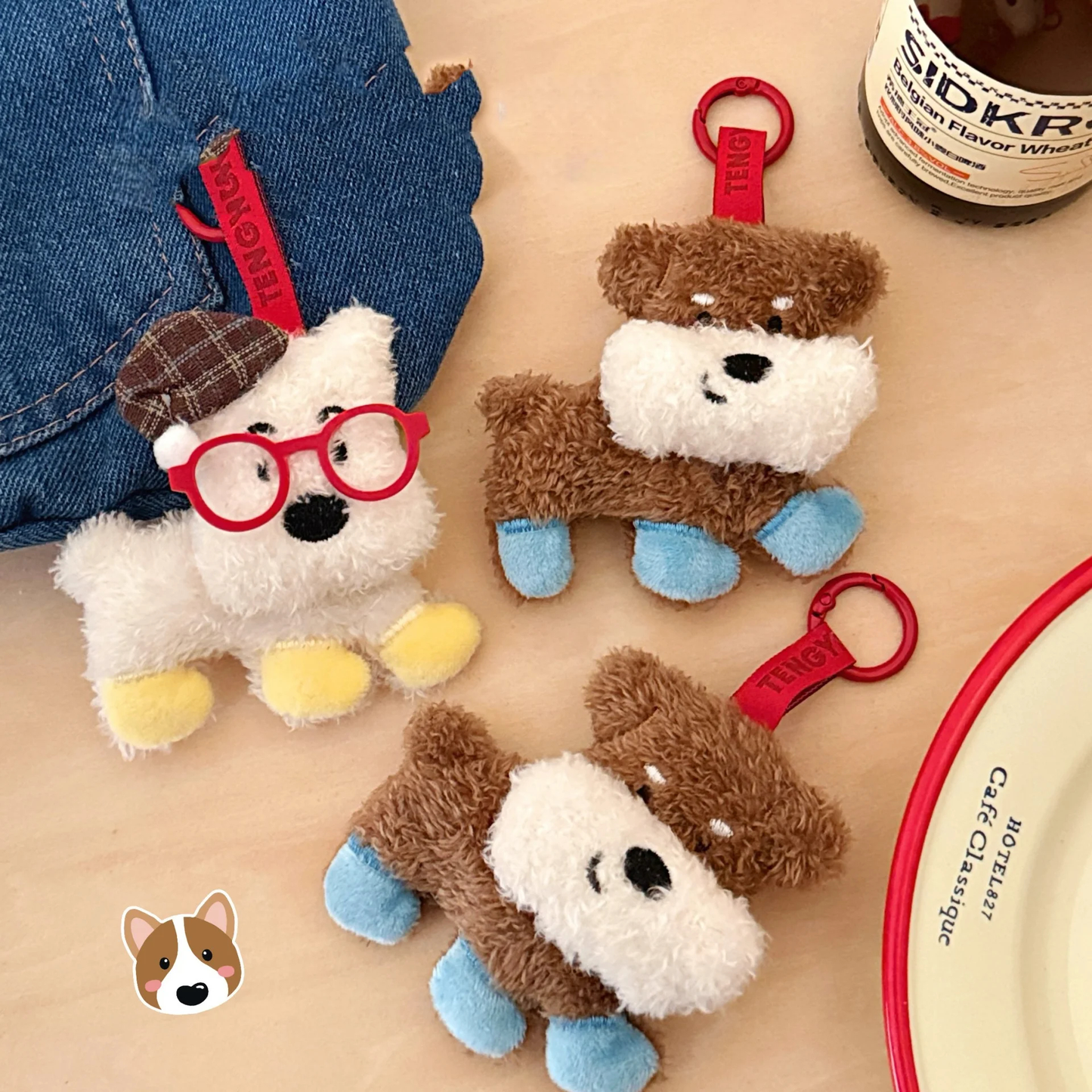 Three plush dog toys with red tags on a wooden surface.