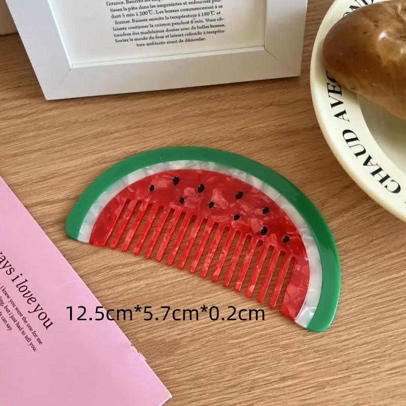 Watermelon-themed comb on a wooden surface with text overlay