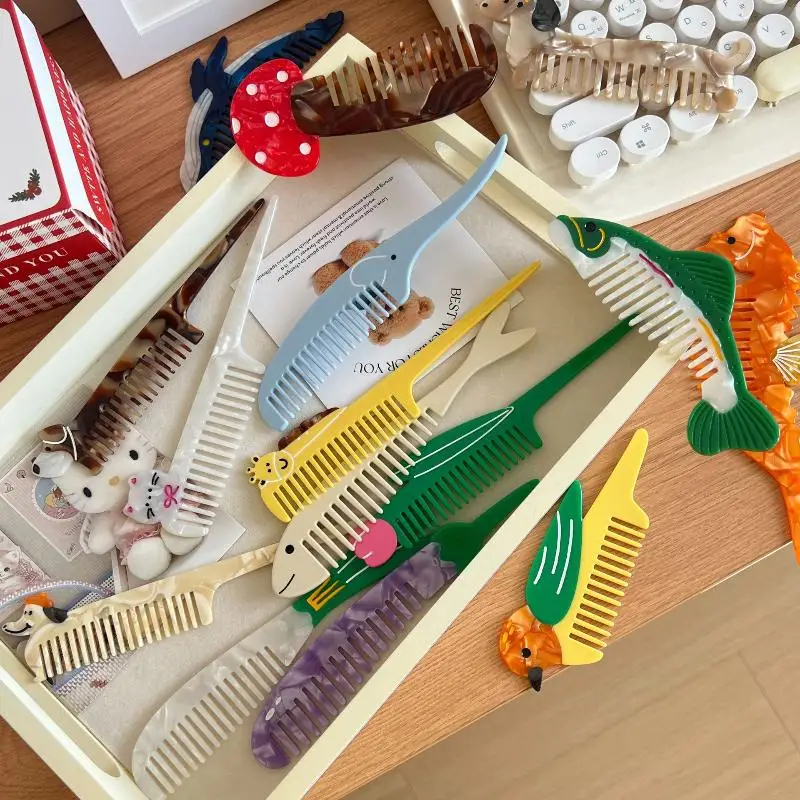 Collection of colorful animal-themed combs in a box on a wooden surface.