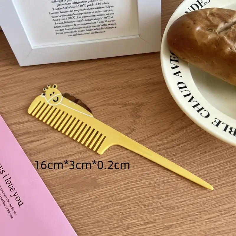 Yellow comb with a giraffe design on a wooden surface