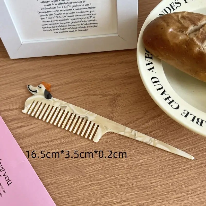 Wooden comb with dog design on a wooden surface next to a loaf of bread.