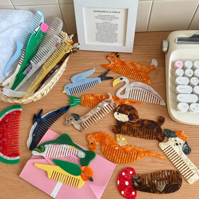 Collection of various animal-themed combs on a wooden surface with a basket and framed picture in the background.