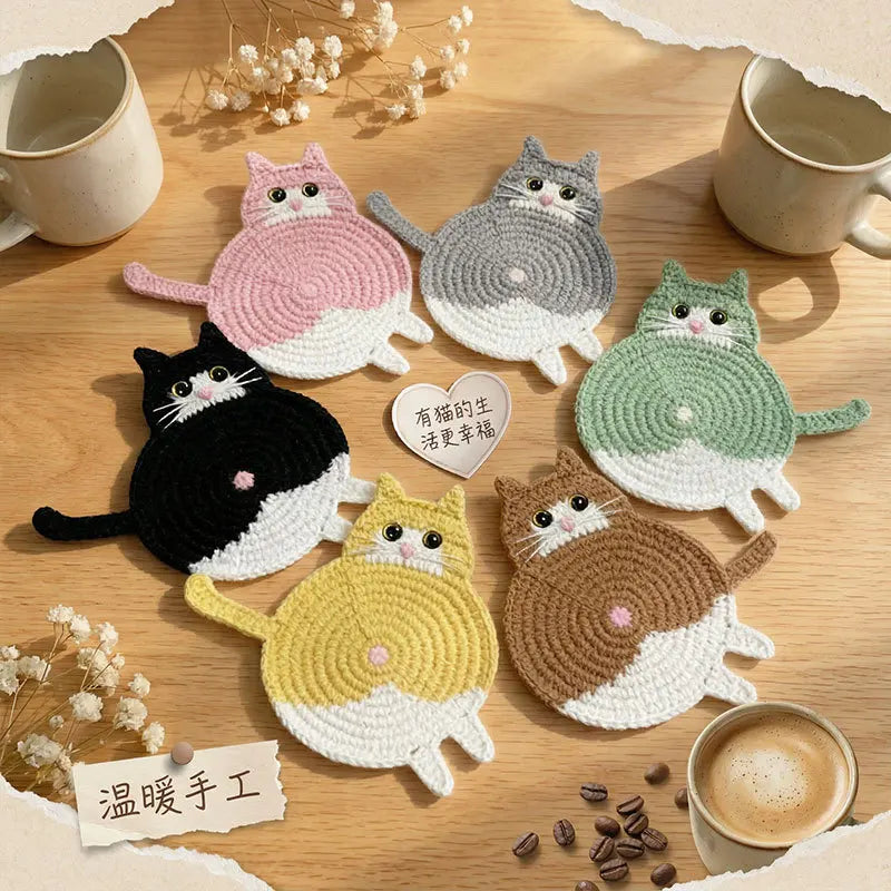 Cat-shaped coasters on a wooden surface with coffee cups and coffee beans.
