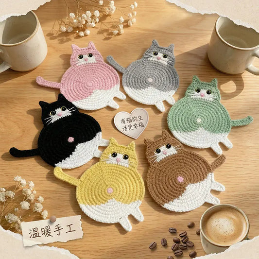 Cat-shaped coasters on a wooden surface with coffee cups and coffee beans.