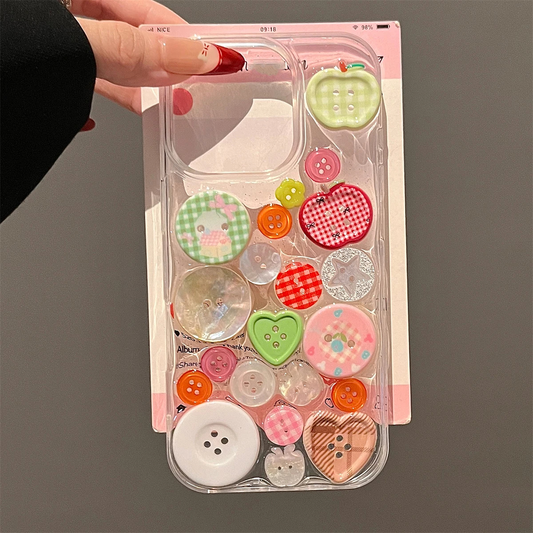 Phone case with colorful buttons held by a hand on a gray background