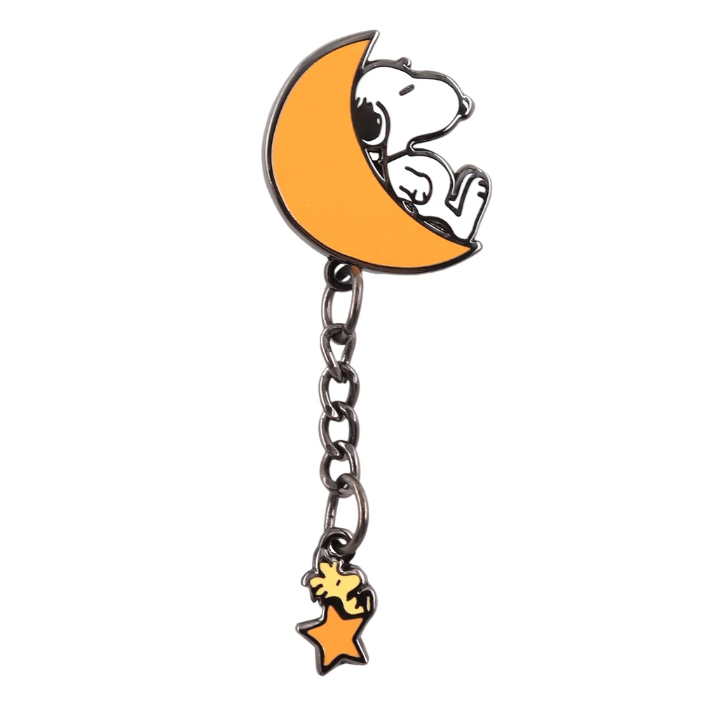Snoopy and Woodstock enamel pin with a crescent moon and star on a white background
