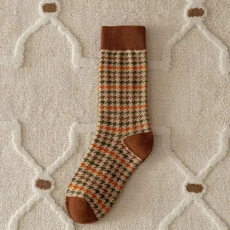 Patterned sock with brown accents on a textured surface