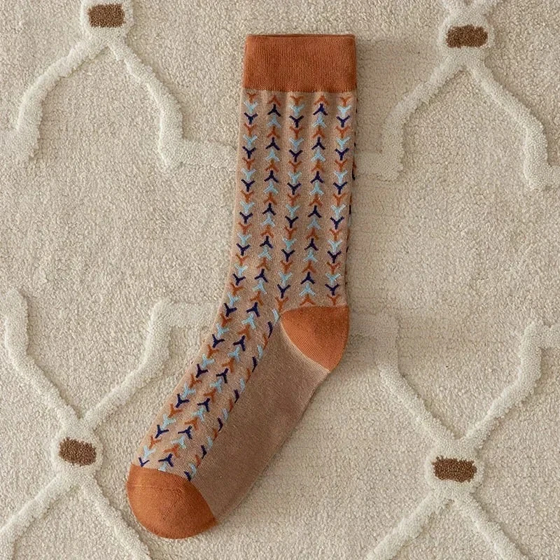 Patterned sock with brown accents on a textured surface