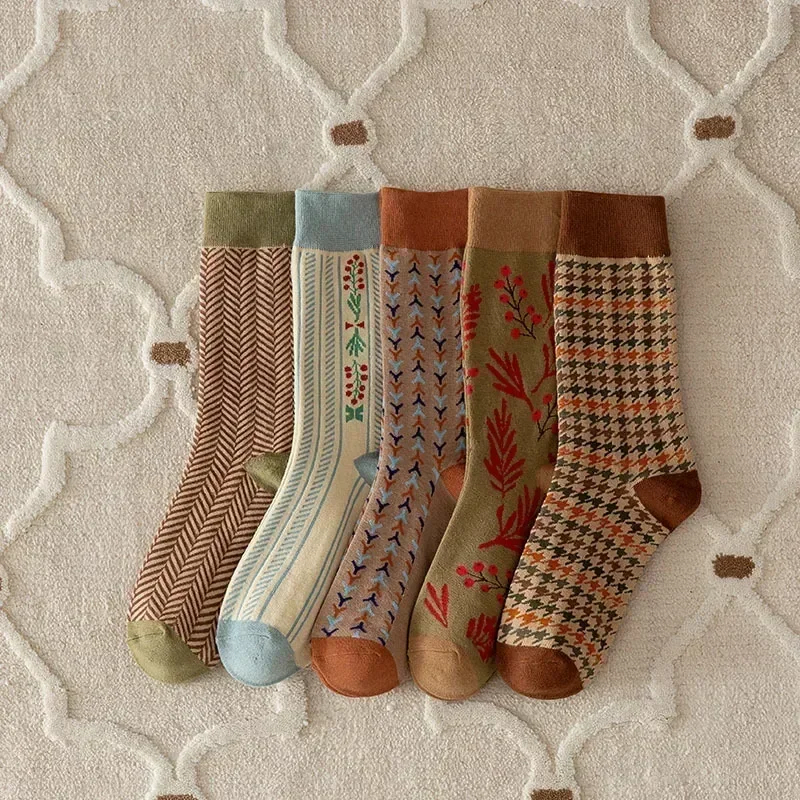 Five patterned socks on a textured surface