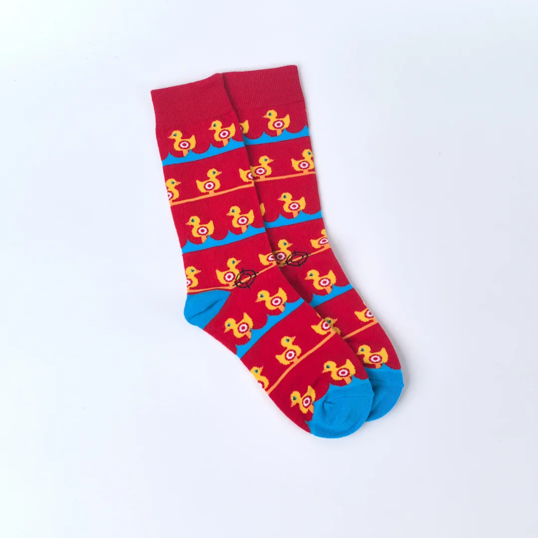 Red socks with yellow duck pattern on a white background