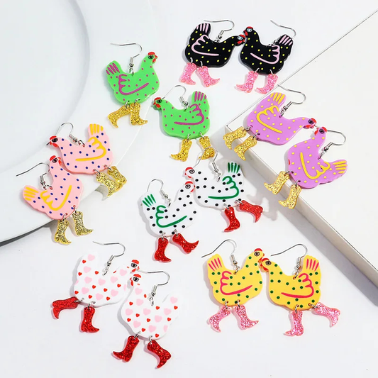 Colorful chicken-shaped earrings on a white surface