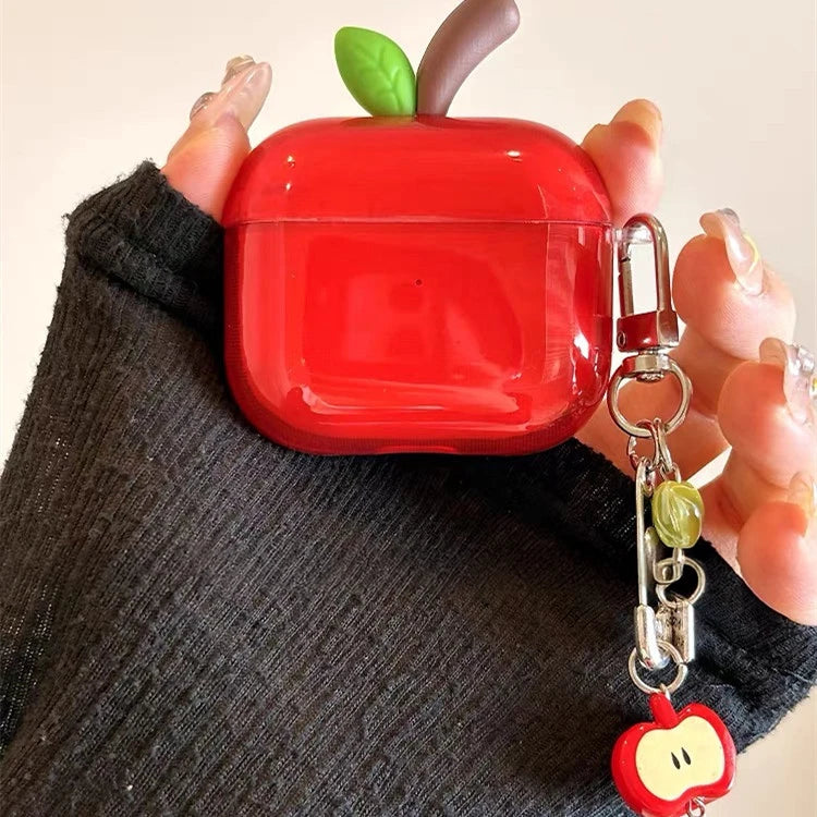 Red apple-shaped airpod case with a keychain held by a person