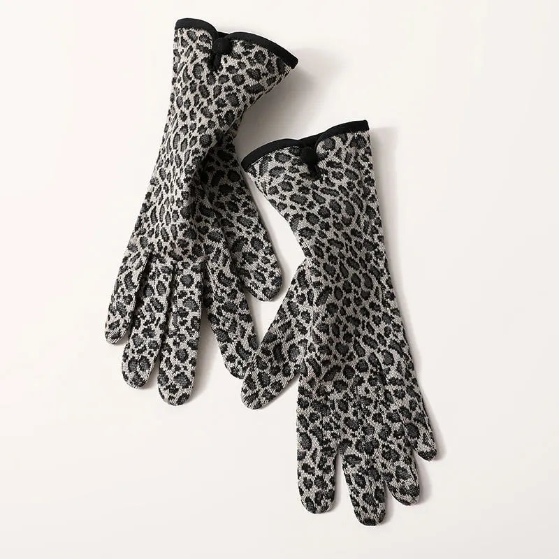 Leopard print gloves with black cuffs on a white background
