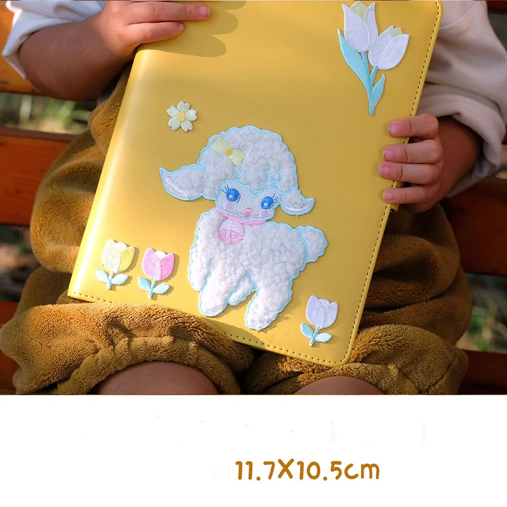 Yellow notebook with a cute lamb design held by a child