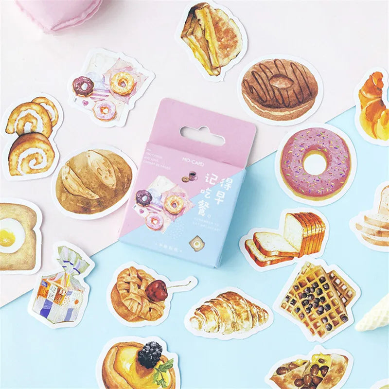 A package of bakery-themed die-cut stickers surrounded by scattered matching illustrations of pastries, breads, donuts, waffles, and desserts on a pastel pink and blue background.