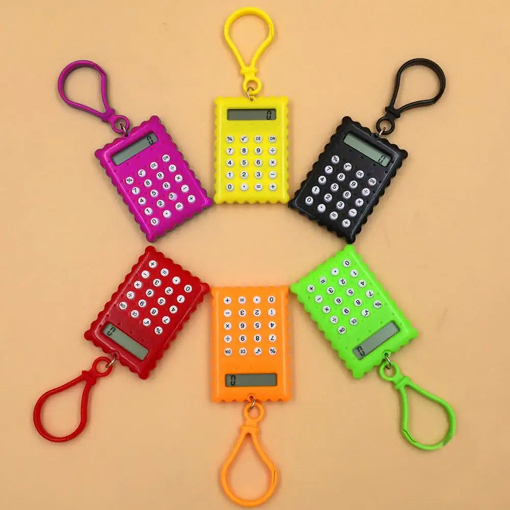 Six small handheld calculator keychains in different colors (purple, yellow, black, red, orange, green) arranged in a circle on a solid beige background.