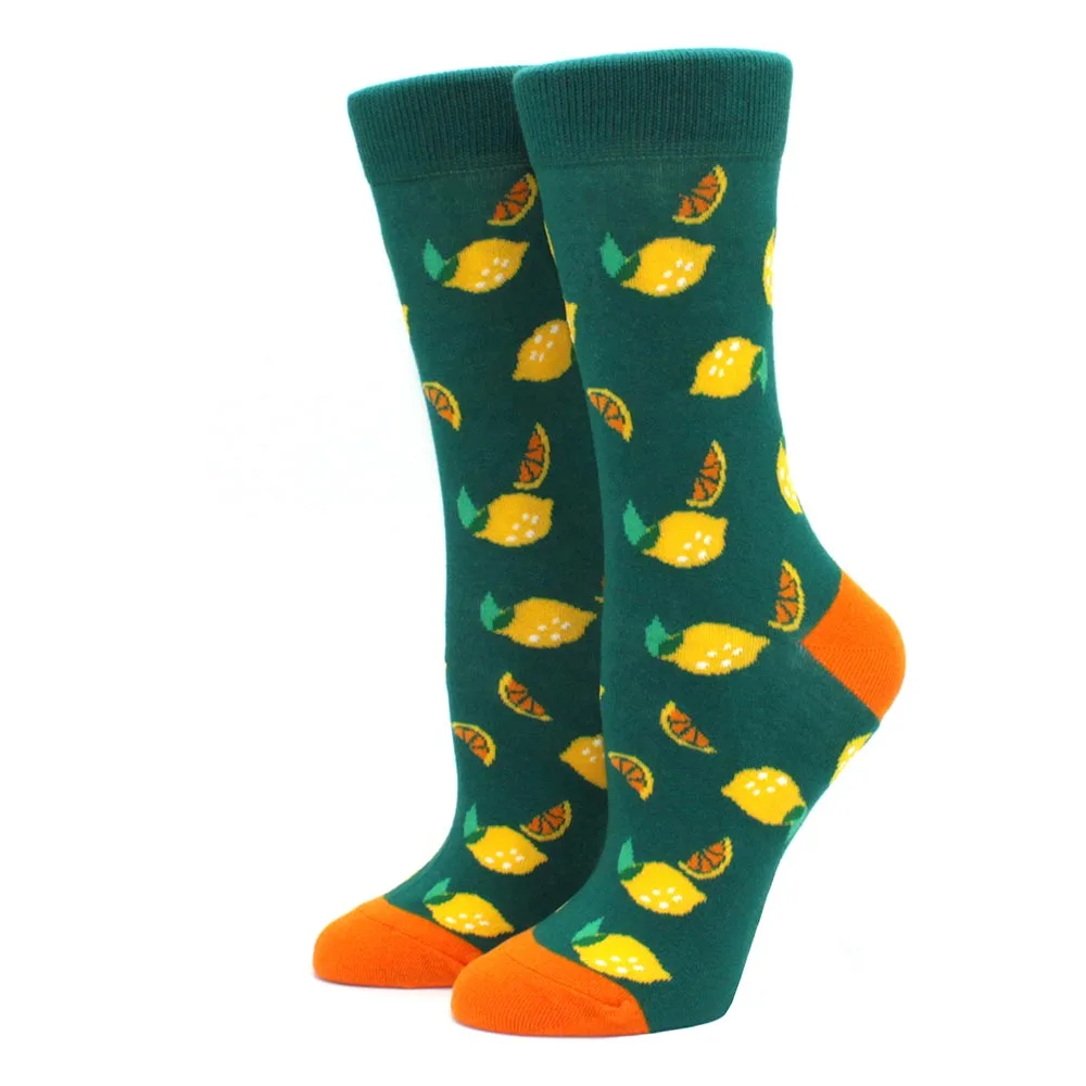 Green socks with lemon pattern and orange toes on a white background