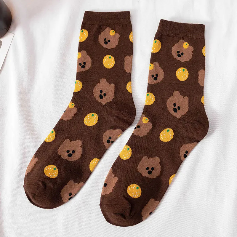 Brown socks with bear and orange pattern on a white background
