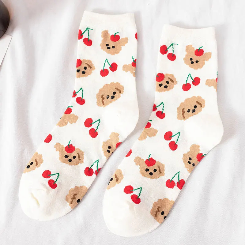 White socks with dog and cherry pattern on a white background