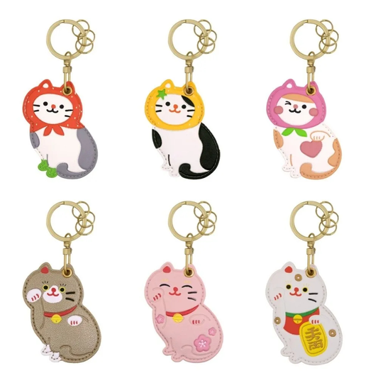 Set of six colorful cat-shaped keychains on a white background