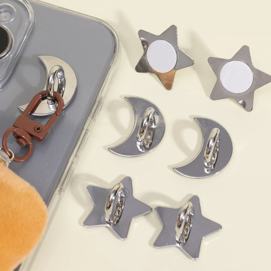 Star-shaped charm loops with a keychain and phone case on a light background