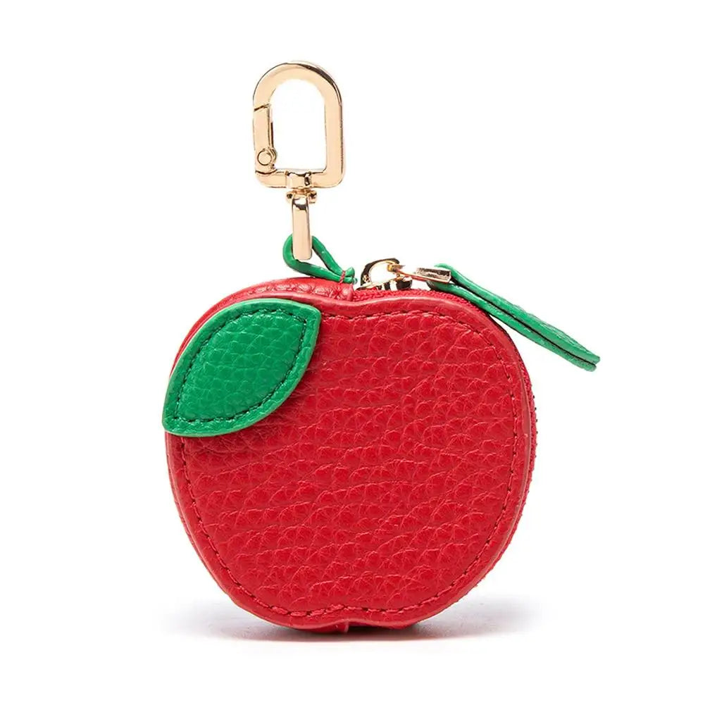 Red apple-shaped keychain pouch with a green leaf on a white background