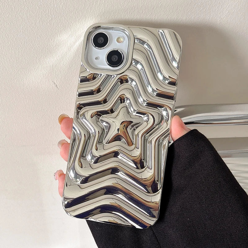 Metallic phone case with star design held by a person against a neutral background
