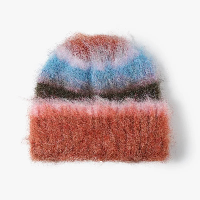 A fuzzy knit beanie hat with horizontal stripes in dusty pink, light blue, dark brown, and muted orange, shown on a clean white background.