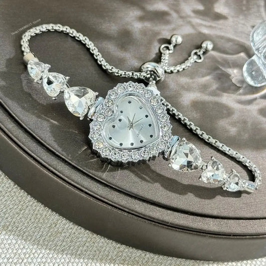 Silver necklace with a clock face and crystal-like elements on a textured surface